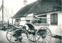 Svinninge Smedie ca. 1914. - Manden på billedet er Niels Peter Jensen og han står foran smedien med en Charabanc.